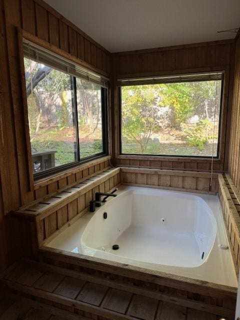 bathroom with a healthy amount of sunlight and a bath