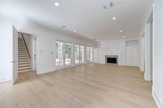 unfurnished living room featuring french doors, light hardwood / wood-style floors, and ornamental molding