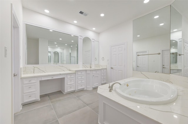 bathroom featuring vanity, tile patterned floors, and a bathtub