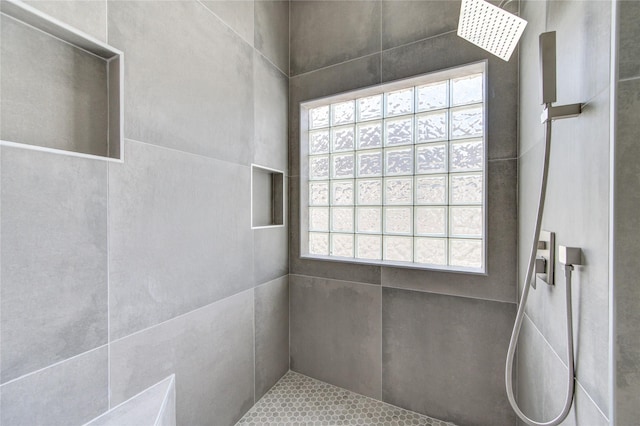 bathroom featuring a shower and a wealth of natural light