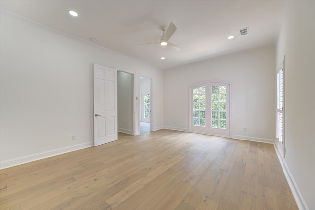 spare room featuring ceiling fan, ornamental molding, and light hardwood / wood-style flooring