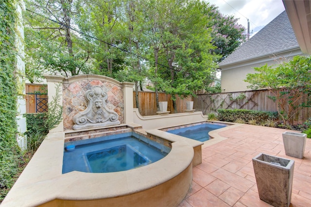 view of pool featuring an in ground hot tub and a patio area