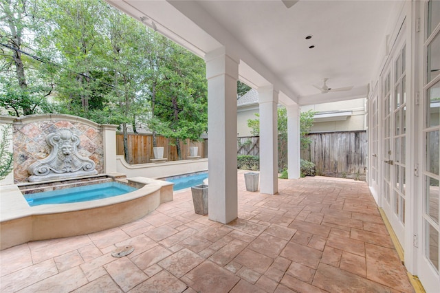 view of pool featuring a patio area and an in ground hot tub