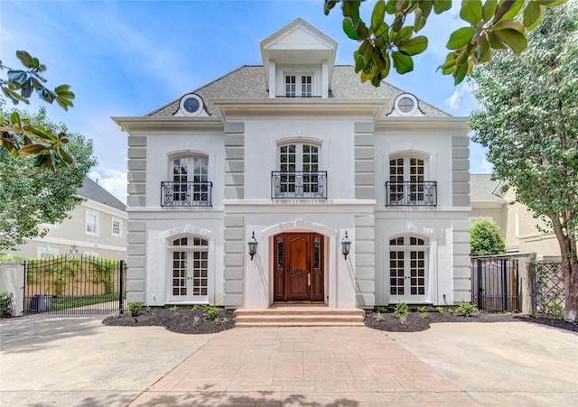 view of front of home with french doors and a balcony