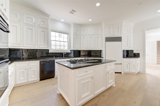 kitchen with white cabinetry, a kitchen island, paneled refrigerator, and black dishwasher