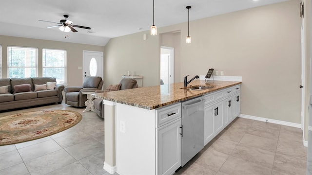 kitchen featuring light stone counters, a peninsula, a sink, white cabinetry, and dishwasher