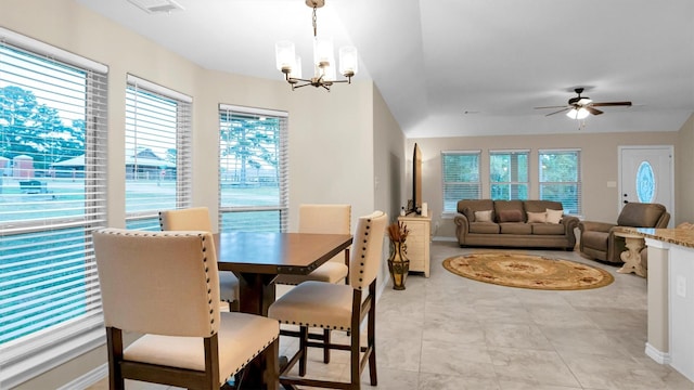 dining room with a wealth of natural light, visible vents, baseboards, and ceiling fan with notable chandelier