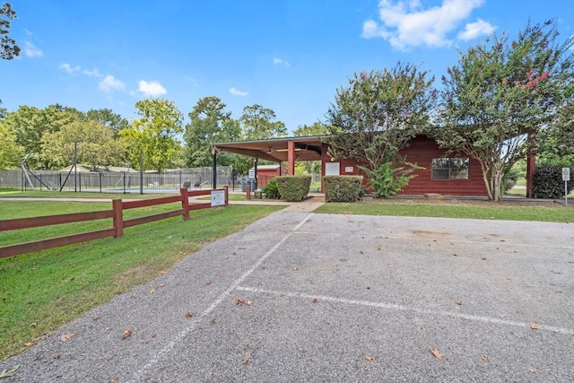 view of front of house featuring uncovered parking and a front yard