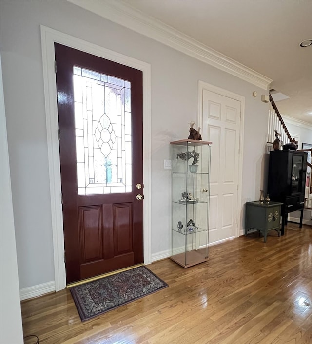 foyer entrance featuring hardwood / wood-style flooring and ornamental molding