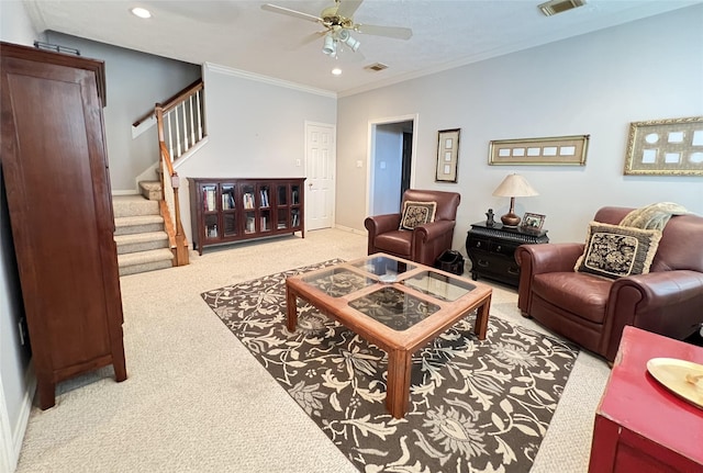 carpeted living room with ceiling fan and crown molding