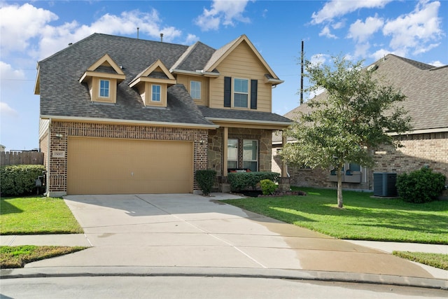 view of front facade with a garage, central air condition unit, and a front lawn