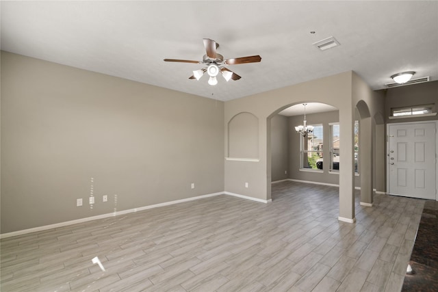 interior space featuring ceiling fan with notable chandelier