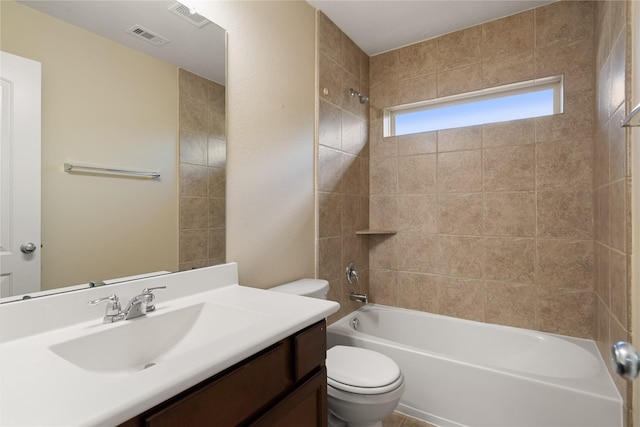 full bathroom with tiled shower / bath combo, toilet, and vanity