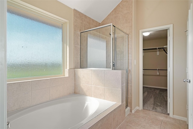 bathroom with vaulted ceiling, tile patterned floors, and independent shower and bath