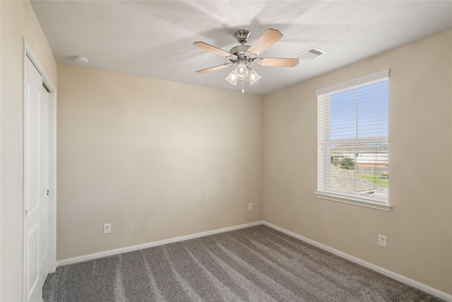 carpeted empty room featuring ceiling fan