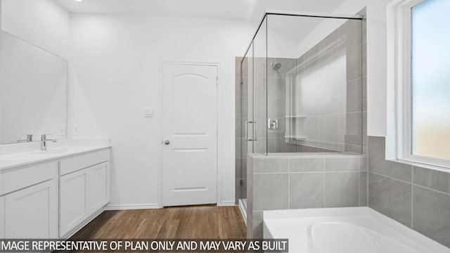 bathroom with hardwood / wood-style floors, vanity, and separate shower and tub