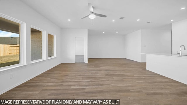 spare room with ceiling fan, wood-type flooring, and sink