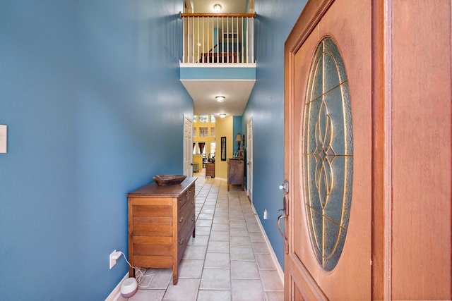 tiled entryway featuring a high ceiling