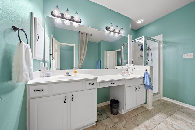 bathroom featuring tile patterned flooring, vanity, and a shower with shower door