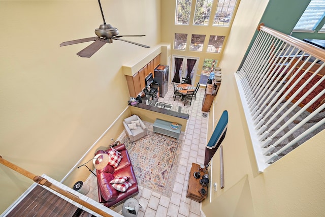 interior space with a high ceiling and ceiling fan