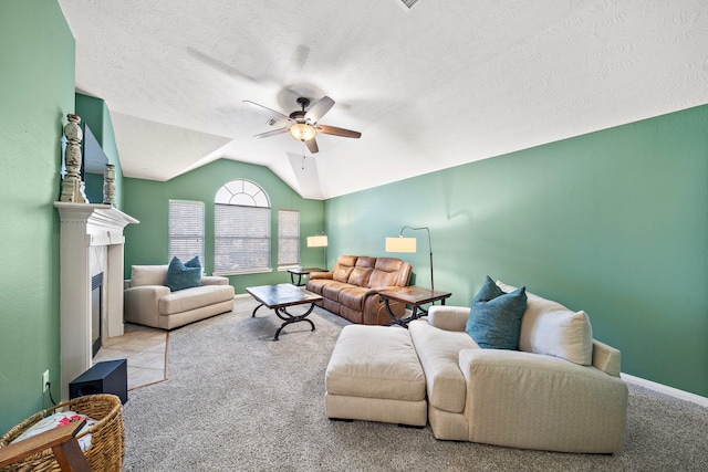 carpeted living room with ceiling fan, a textured ceiling, and vaulted ceiling