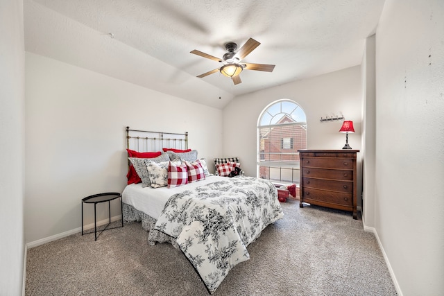 bedroom featuring carpet flooring, ceiling fan, a textured ceiling, and vaulted ceiling