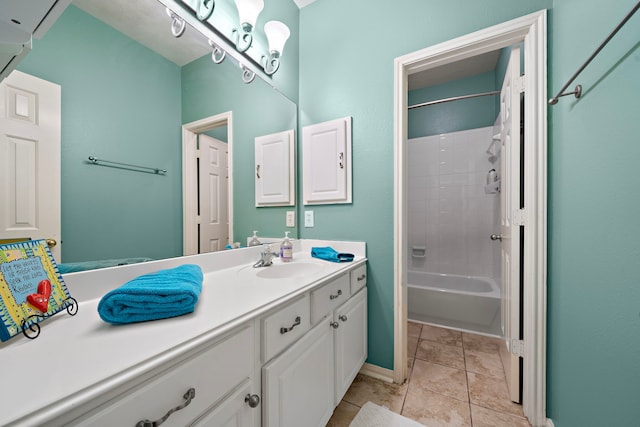 bathroom with tile patterned flooring, vanity, and tiled shower / bath combo