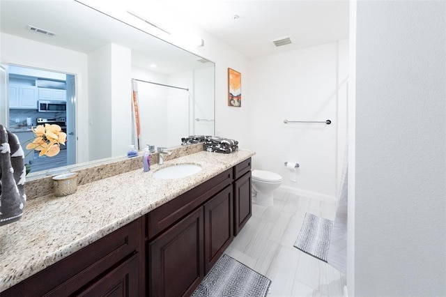 bathroom with walk in shower, vanity, and toilet