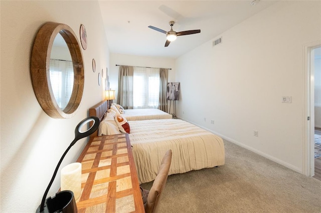 bedroom featuring light carpet and ceiling fan