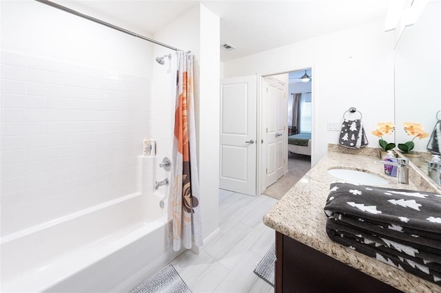 bathroom with shower / bath combo and vanity