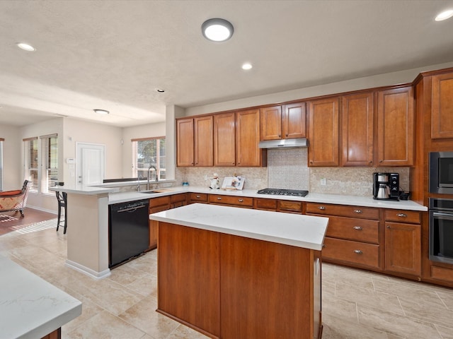 kitchen with sink, a center island, a healthy amount of sunlight, and appliances with stainless steel finishes