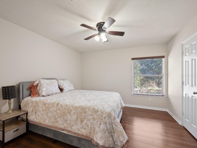 bedroom featuring ceiling fan and dark wood-type flooring