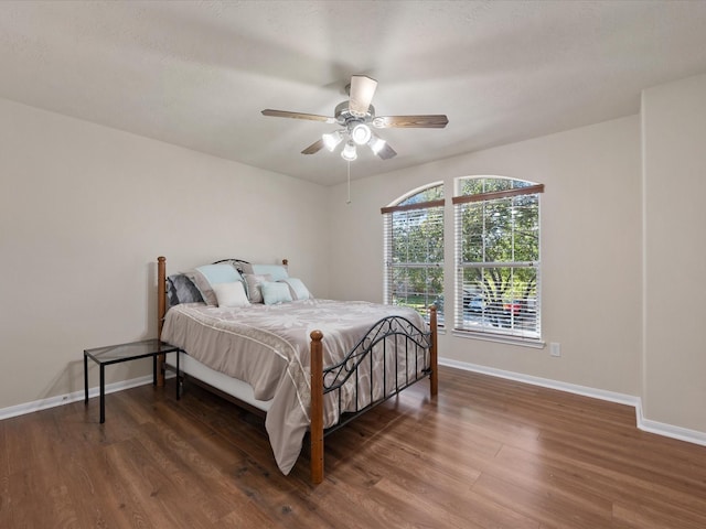 bedroom with ceiling fan and dark hardwood / wood-style floors