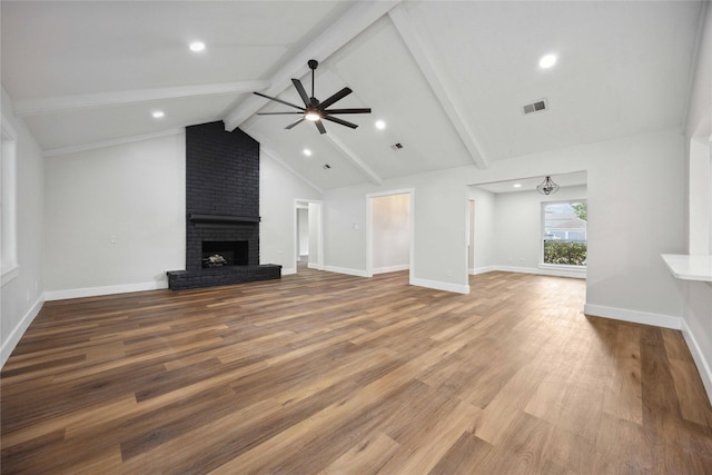 unfurnished living room featuring a brick fireplace, ceiling fan, hardwood / wood-style flooring, high vaulted ceiling, and beamed ceiling