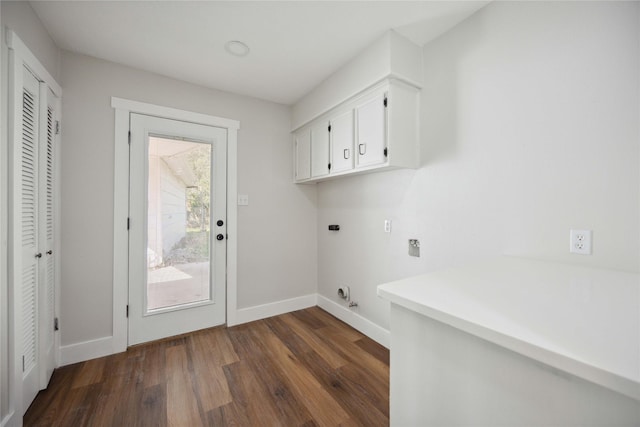 clothes washing area with electric dryer hookup, cabinets, and dark wood-type flooring