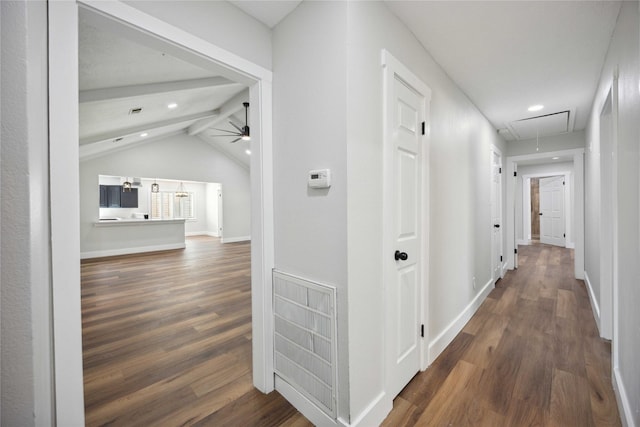 corridor with dark wood-type flooring and lofted ceiling with beams