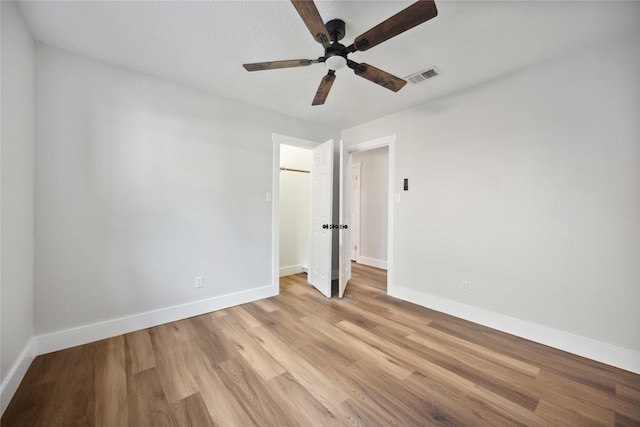 unfurnished room with ceiling fan and light wood-type flooring