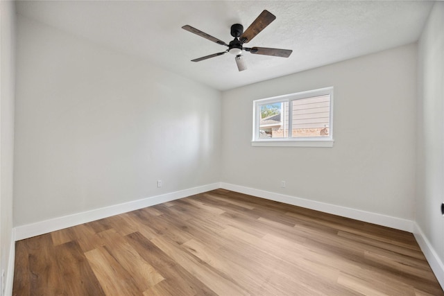 spare room with light hardwood / wood-style flooring and ceiling fan