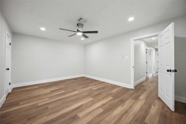 spare room with ceiling fan and dark hardwood / wood-style flooring