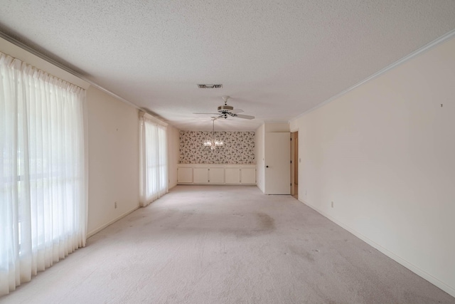 carpeted empty room featuring a textured ceiling, ceiling fan, and ornamental molding