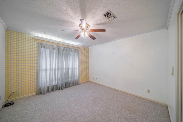 empty room with crown molding, carpet, and ceiling fan