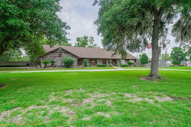 single story home featuring a front lawn