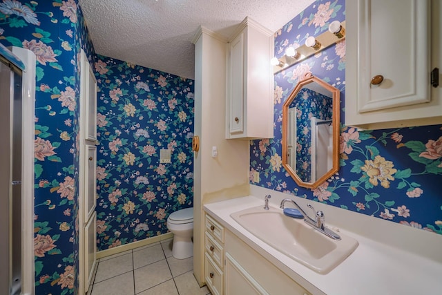 bathroom featuring tile patterned floors, vanity, a textured ceiling, and toilet