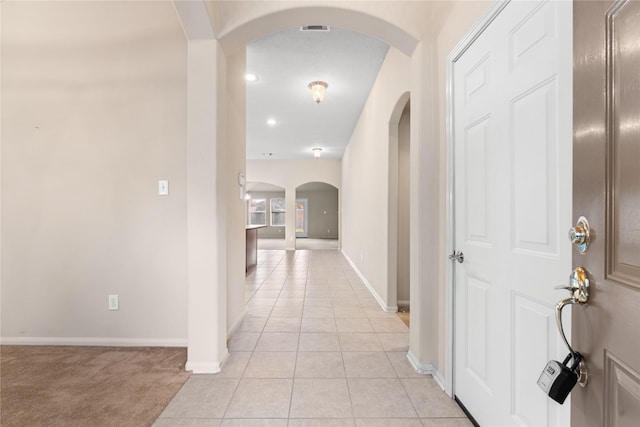 corridor with light tile patterned flooring