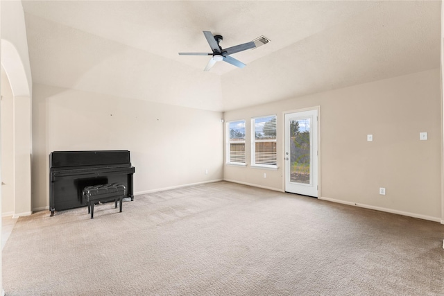 carpeted spare room featuring ceiling fan and lofted ceiling