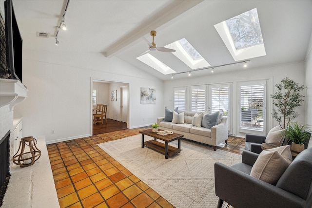 tiled living room with ceiling fan and lofted ceiling with beams