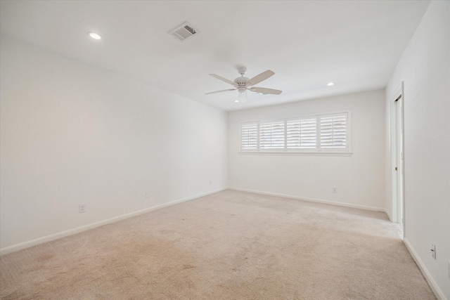 carpeted spare room with ceiling fan