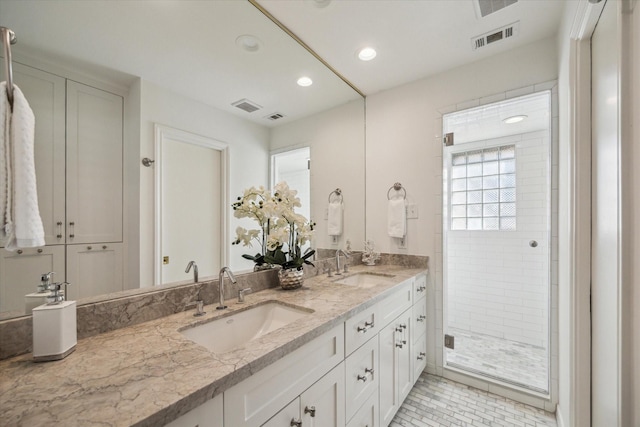 bathroom featuring vanity and an enclosed shower