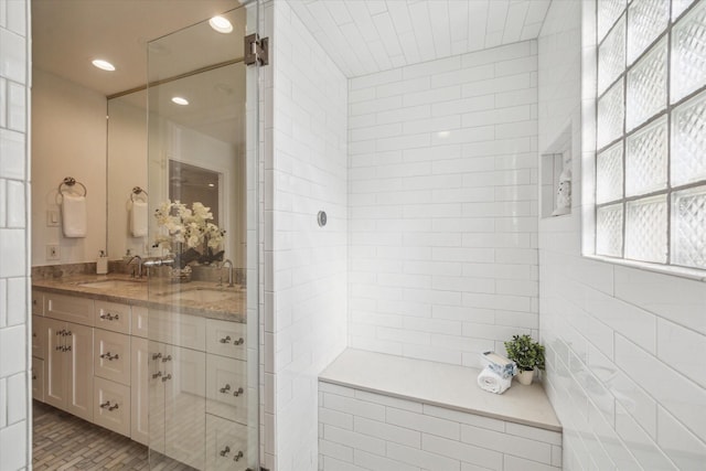 bathroom featuring vanity and tiled shower