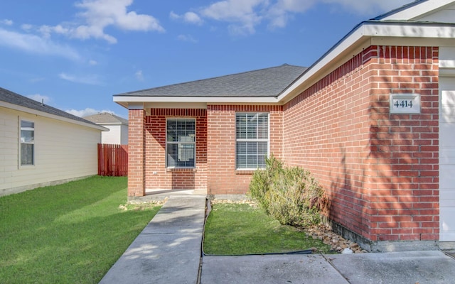 doorway to property with a yard